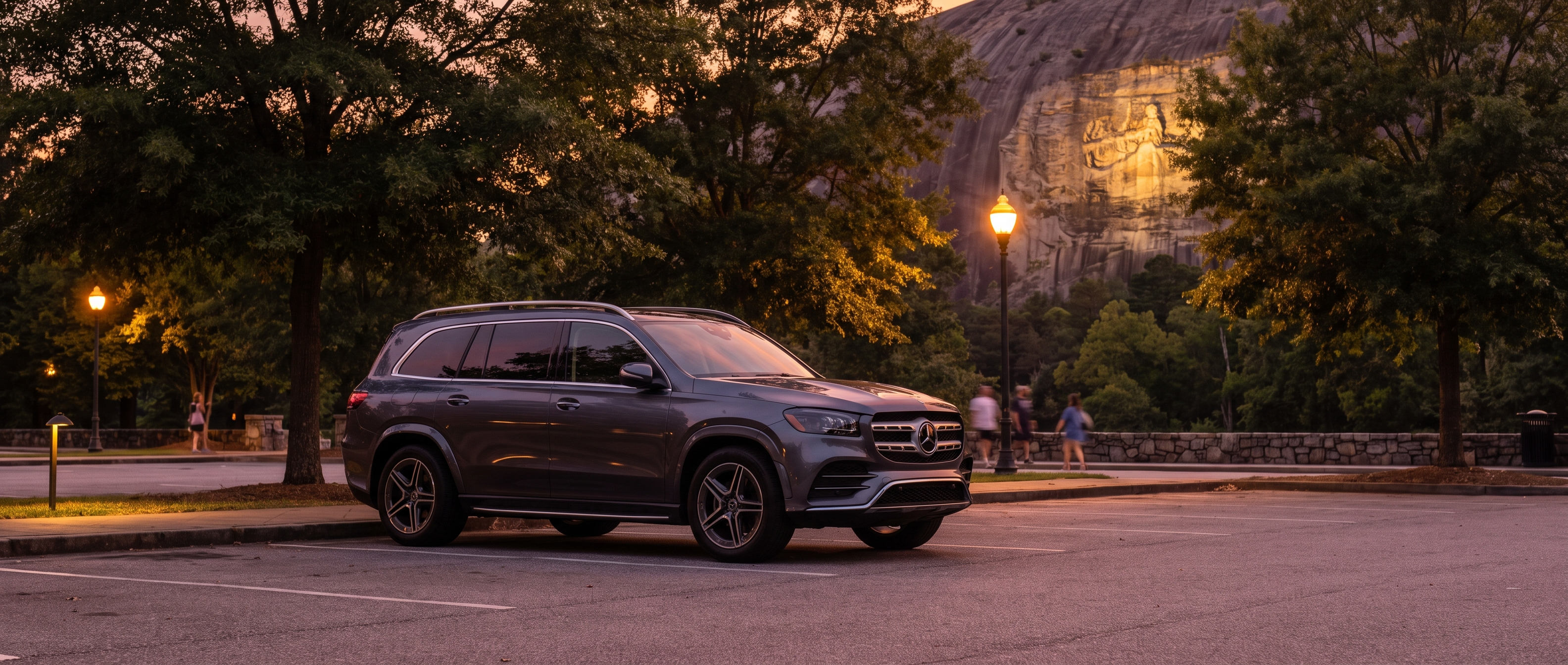 Mercedes-Benz GLS parked at Stone Mountain Park at dusk for an evening light show event